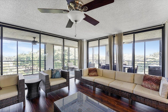 7572 Regency Lake Dr Unit 501, Boca Raton, FL 33433 - sunroom / solarium featuring a wall of windows, a textured ceiling, and wood finished floors