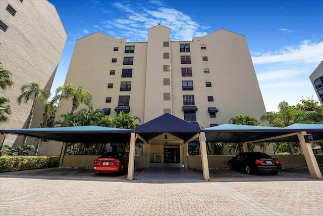 7572 Regency Lake Dr Unit 501, Boca Raton, FL 33433 - view of property featuring covered parking