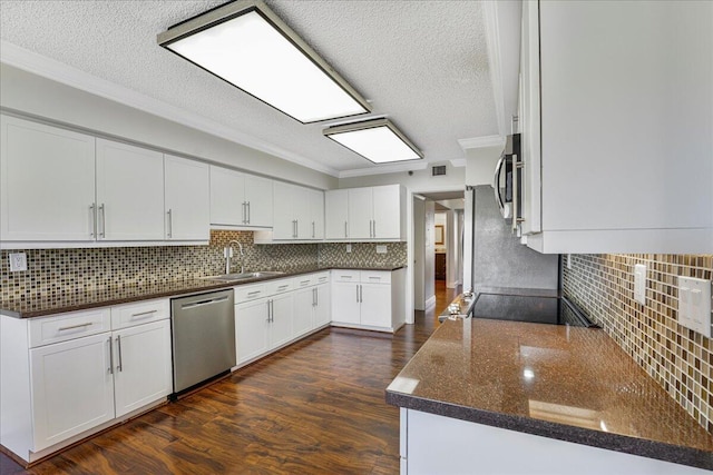 7572 Regency Lake Dr Unit 501, Boca Raton, FL 33433 - kitchen featuring appliances with stainless steel finishes, a sink, a textured ceiling, decorative backsplash, and dark wood finished floors