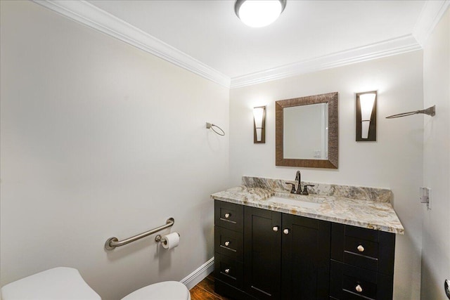 7572 Regency Lake Dr Unit 501, Boca Raton, FL 33433 - bathroom featuring toilet, ornamental molding, vanity, baseboards, and wood finished floors