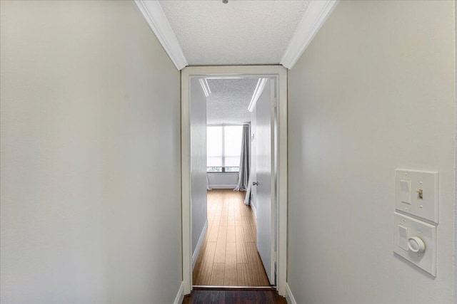 7572 Regency Lake Dr Unit 501, Boca Raton, FL 33433 - hall with a textured ceiling, crown molding, baseboards, and dark wood-type flooring