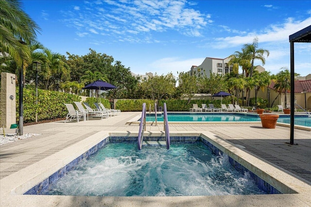 7572 Regency Lake Dr Unit 501, Boca Raton, FL 33433 - community pool with a hot tub and a patio