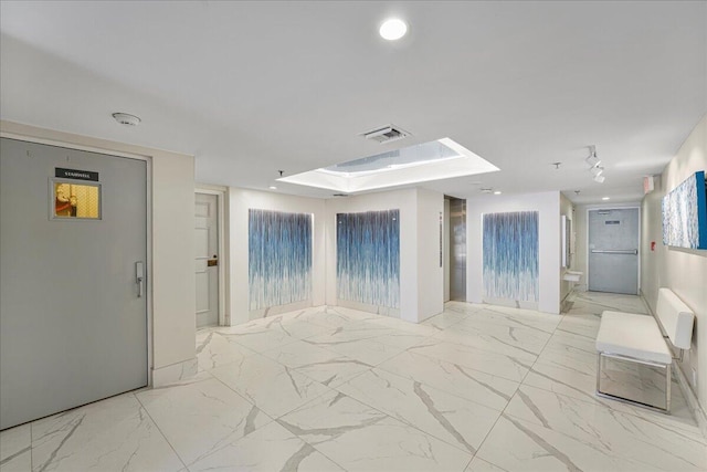 7572 Regency Lake Dr Unit 501, Boca Raton, FL 33433 - empty room featuring a skylight, a smoke detector, marble look tile flooring, and recessed lighting