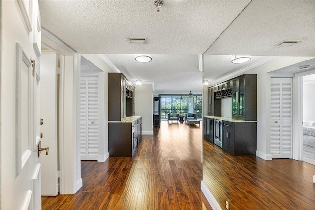 7572 Regency Lake Dr Unit 501, Boca Raton, FL 33433 - hall with a textured ceiling, dark wood finished floors, crown molding, and baseboards