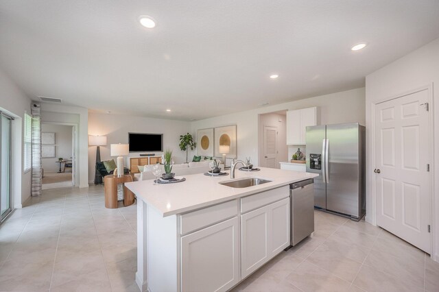 5810 NW Blue Bonnet Ct, Port Saint Lucie, FL 34986 - kitchen with white cabinets, a sink, light countertops, appliances with stainless steel finishes, and an island with sink