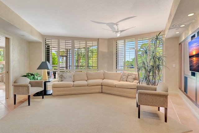 living area with a ceiling fan, light tile patterned flooring, and recessed lighting
