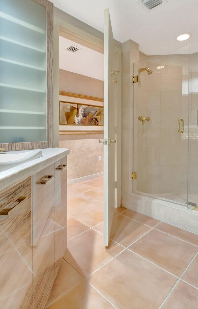 full bathroom featuring a stall shower, tile patterned flooring, visible vents, and vanity
