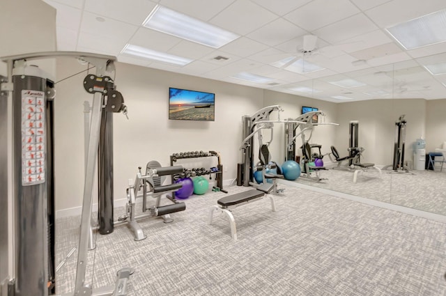 exercise area featuring a paneled ceiling, visible vents, and carpet floors