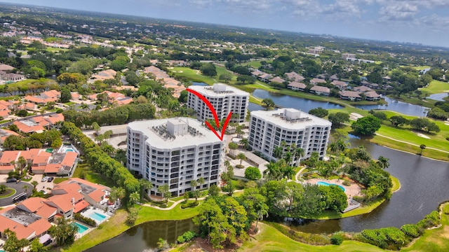 bird's eye view with view of golf course and a water view