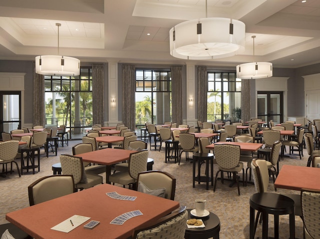 carpeted dining area with ornamental molding, a decorative wall, coffered ceiling, and a towering ceiling