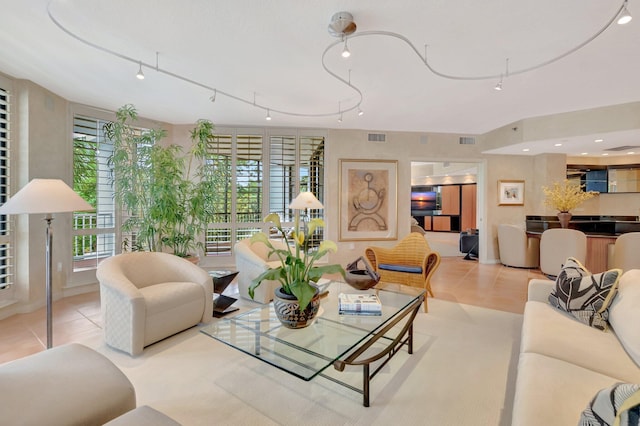 tiled living room with track lighting and visible vents