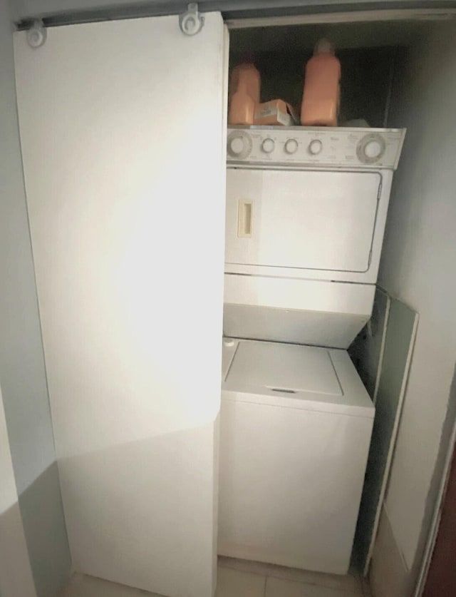 laundry area with stacked washer / drying machine