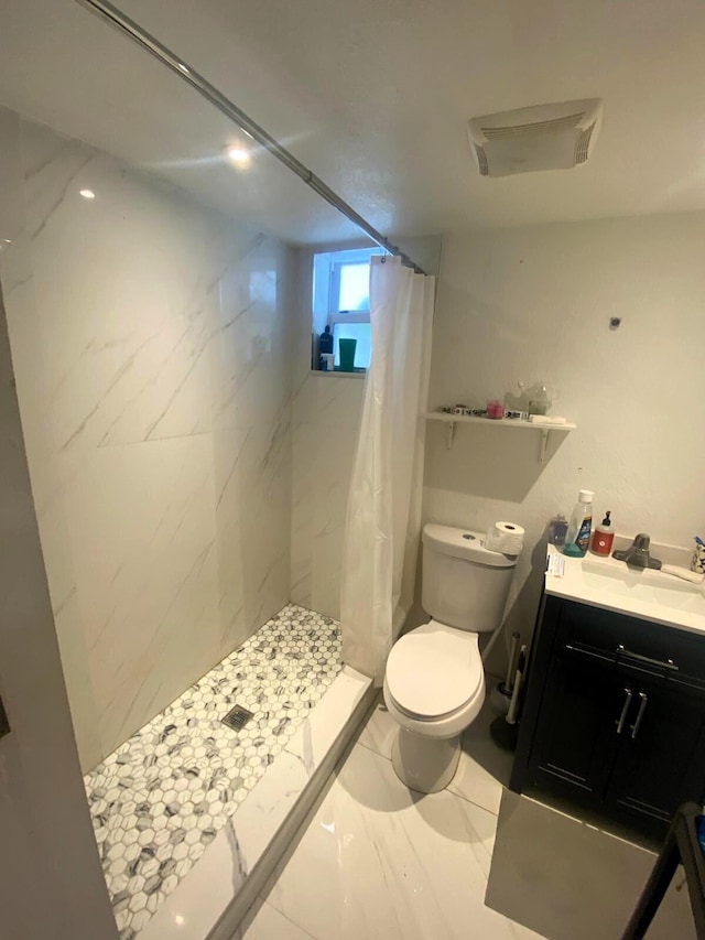 full bathroom with vanity, marble finish floor, a shower stall, and toilet