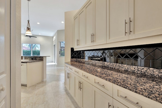 5266 Landon Cir, Boynton Beach, FL 33437 - kitchen with baseboards, recessed lighting, dark stone counters, backsplash, and pendant lighting