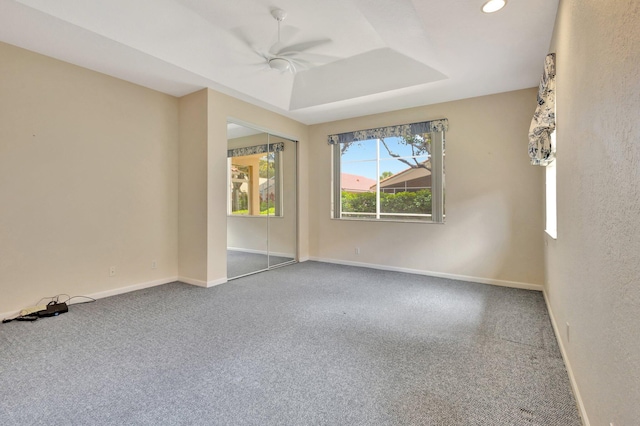 5266 Landon Cir, Boynton Beach, FL 33437 - spare room featuring a tray ceiling, baseboards, a ceiling fan, and carpet