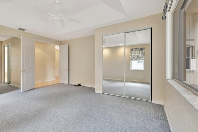5266 Landon Cir, Boynton Beach, FL 33437 - unfurnished bedroom with a closet, baseboards, carpet flooring, visible vents, and arched walkways