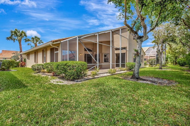 5266 Landon Cir, Boynton Beach, FL 33437 - rear view of property featuring stucco siding, glass enclosure, a lawn, and a tile roof