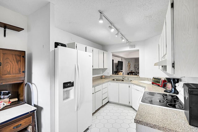 kitchen featuring visible vents, a sink, light countertops, white appliances, and a textured ceiling