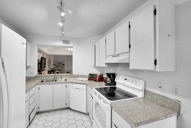 kitchen featuring white appliances, visible vents, under cabinet range hood, light countertops, and a sink