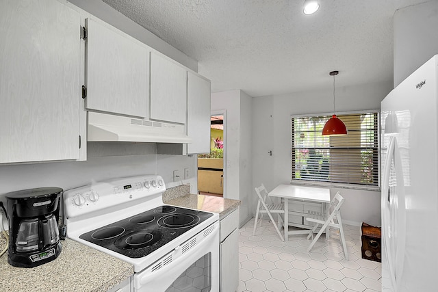 kitchen featuring hanging light fixtures, light countertops, white appliances, a textured ceiling, and under cabinet range hood