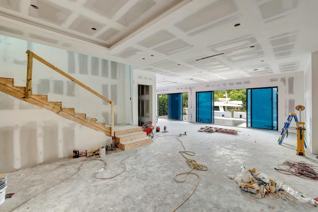 unfurnished living room with stairway