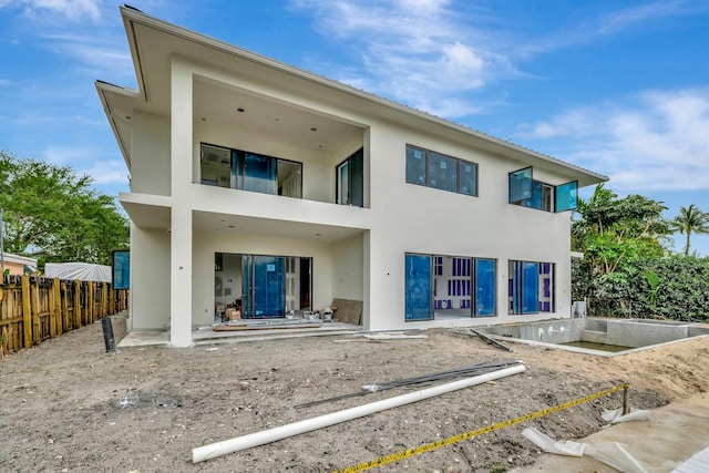 back of house featuring fence, a patio, and stucco siding