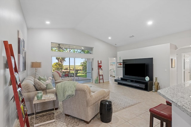 living area featuring recessed lighting, light tile patterned flooring, high vaulted ceiling, and arched walkways