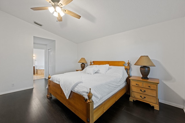bedroom with wood finished floors, visible vents, vaulted ceiling, and baseboards