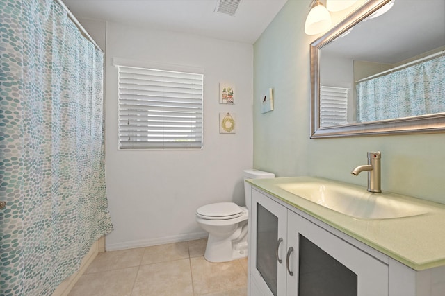 bathroom featuring tile patterned floors, a shower with shower curtain, toilet, vanity, and visible vents