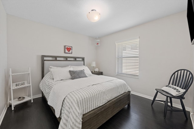 bedroom with wood finished floors and baseboards