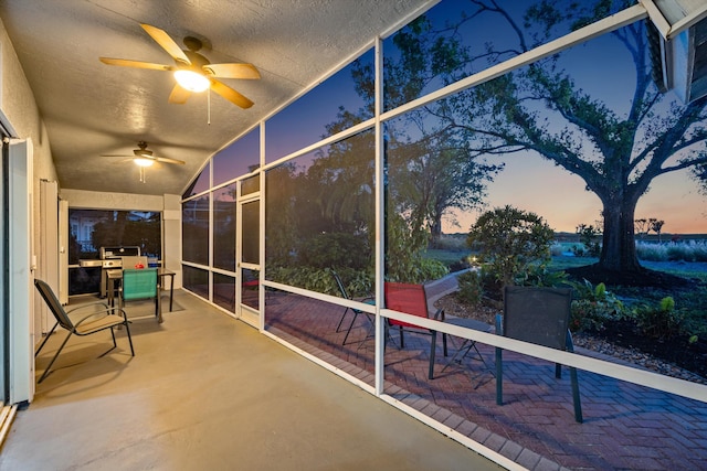 sunroom / solarium featuring ceiling fan