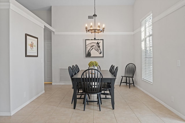dining space with light tile patterned floors, a chandelier, visible vents, baseboards, and a towering ceiling