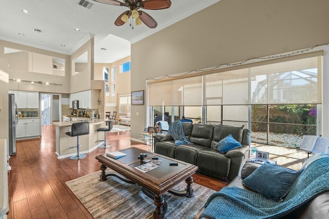 2476 NW 67th St, Boca Raton, FL 33496 - living room with a wealth of natural light, a towering ceiling, a ceiling fan, ornamental molding, and visible vents