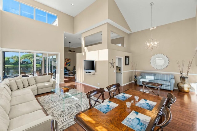 2476 NW 67th St, Boca Raton, FL 33496 - living room featuring baseboards, wood finished floors, plenty of natural light, and a towering ceiling