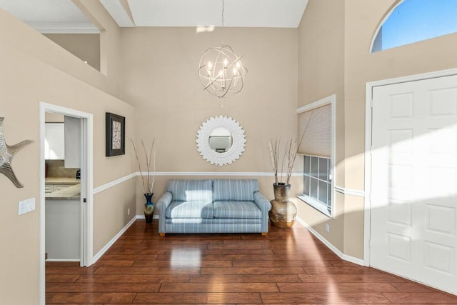 2476 NW 67th St, Boca Raton, FL 33496 - living area with a chandelier, wood-type flooring, baseboards, and a high ceiling