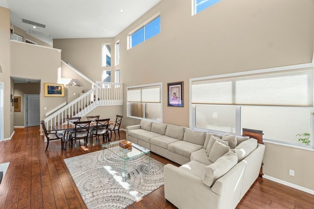 2476 NW 67th St, Boca Raton, FL 33496 - living area featuring stairs, a towering ceiling, baseboards, and hardwood / wood-style floors