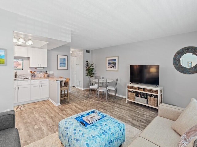 2800 Indian River Blvd Unit F8, Vero Beach, FL 32960 - living area with light wood-style flooring and baseboards
