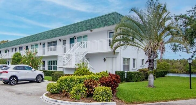 2800 Indian River Blvd Unit F8, Vero Beach, FL 32960 - view of property with stairway and uncovered parking