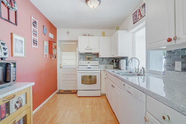 kitchen with a sink, decorative backsplash, under cabinet range hood, and white appliances