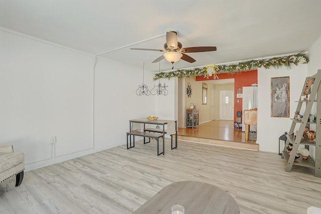 sitting room with a ceiling fan and light wood-style flooring