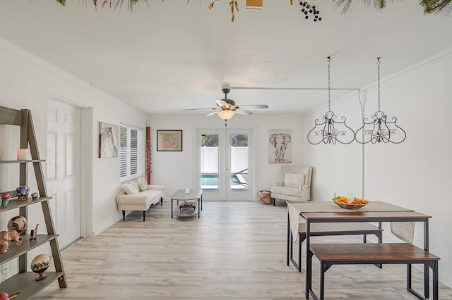 living area featuring ceiling fan, french doors, and light wood-type flooring