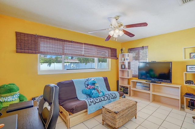 living area featuring tile patterned flooring and a ceiling fan