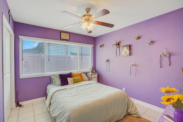 tiled bedroom with baseboards, multiple windows, and ceiling fan