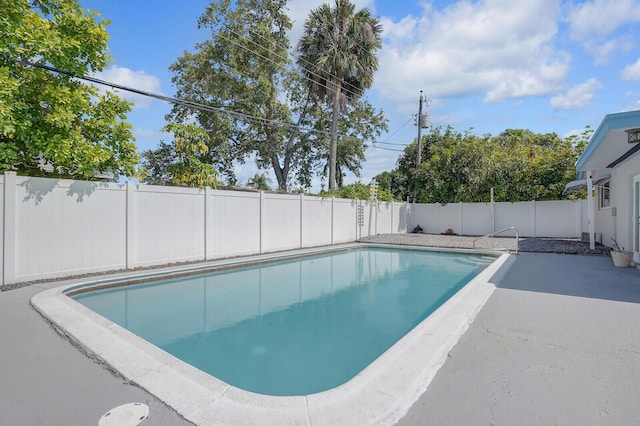 view of swimming pool with a fenced in pool, a fenced backyard, and a patio area