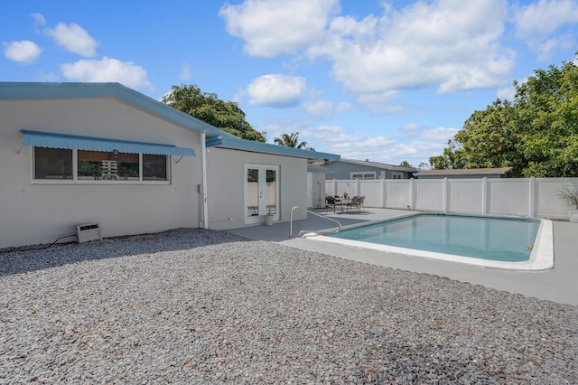 view of pool featuring a fenced in pool, fence, french doors, and a patio
