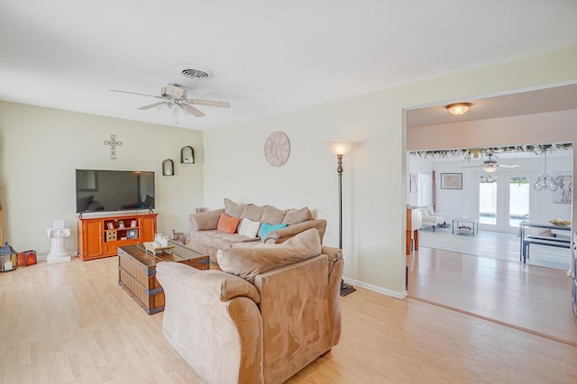 living area with ceiling fan, visible vents, baseboards, and light wood-type flooring