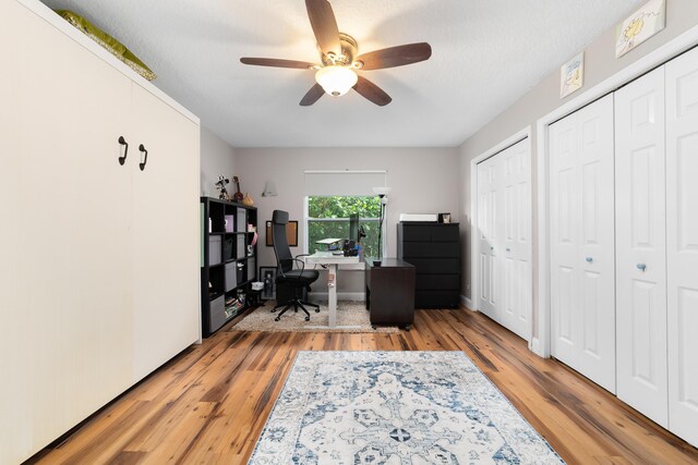 office featuring light wood-style floors and ceiling fan