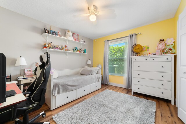 bedroom featuring a ceiling fan and wood finished floors