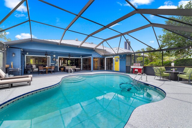 outdoor pool with outdoor dining space, ceiling fan, an outdoor living space, a patio area, and a lanai