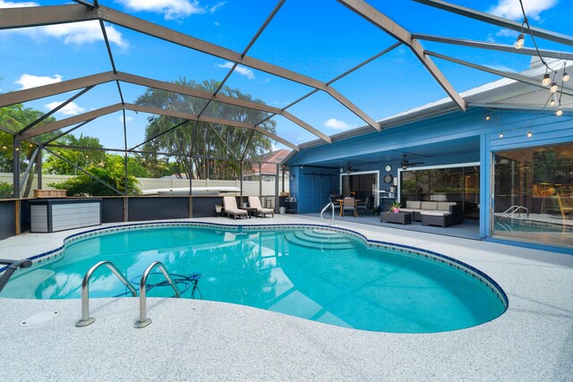 outdoor pool with an outdoor hangout area, a ceiling fan, a patio, and glass enclosure